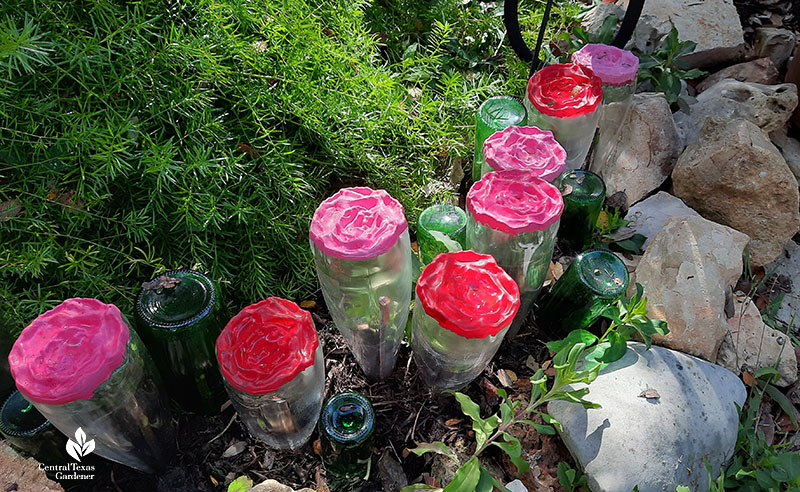upturned wine bottles rose-embossed bottoms painted pink and red 