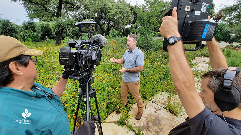 camera crew with host in wildflower prairie 