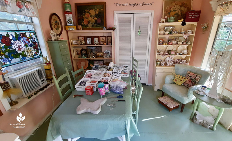 cute she-shed interior painted furniture table with container of broken china pieces 