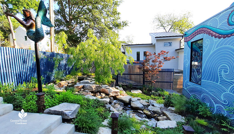 front yard streambed with mermaid sculpture and octopus and ocean house mural 