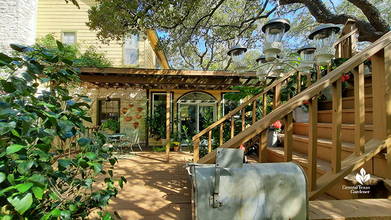 deck and staircase against house; old mailbox in front 