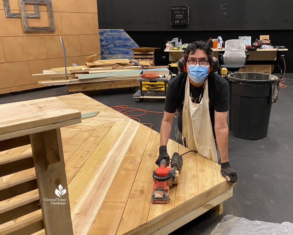 man with mask sanding studio platform