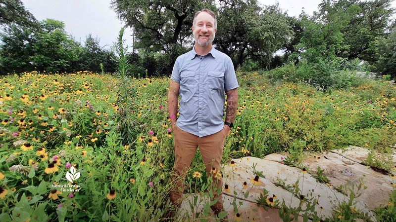 man standing in field of wildflowers 