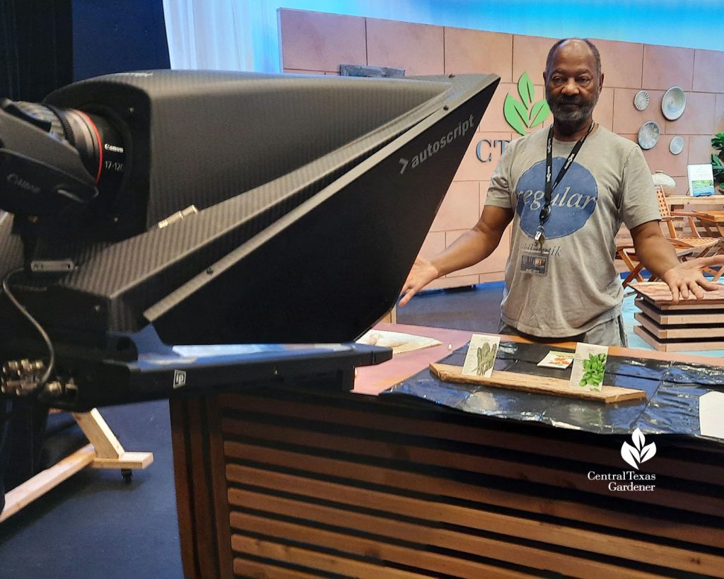 man standing in front of a camera in TV studio