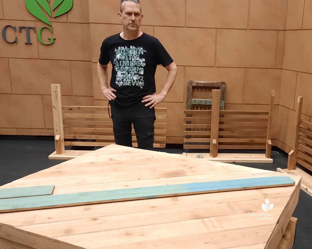 man looking at raw lumber and paint sample  wood 