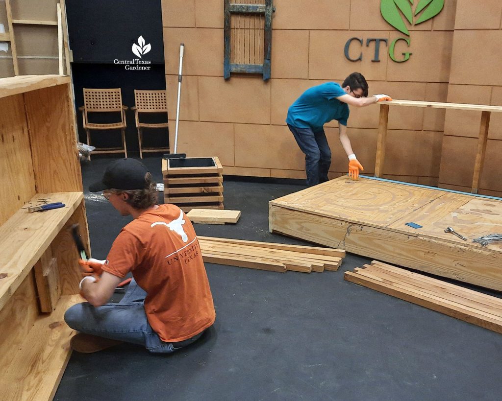 Two college-age students working on TV studio set