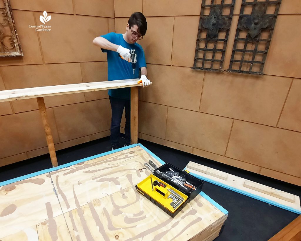 young man drilling a rail on a TV set