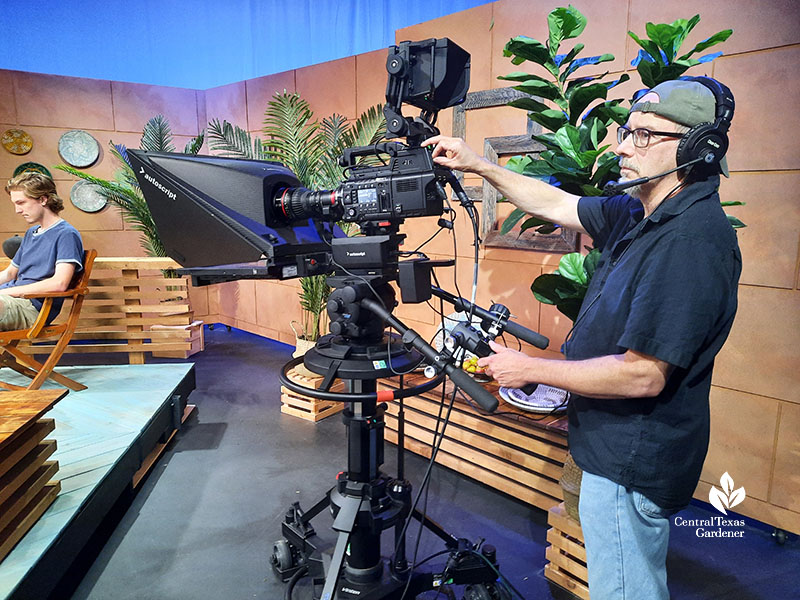 man with TV camera on studio set 