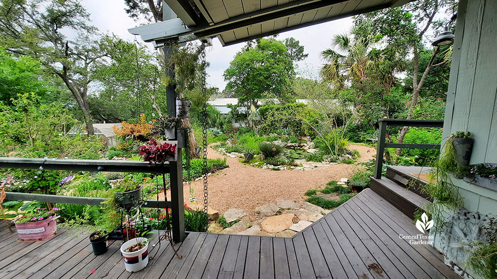 covered patio deck to pea gravel paths and island garden beds and small pond
