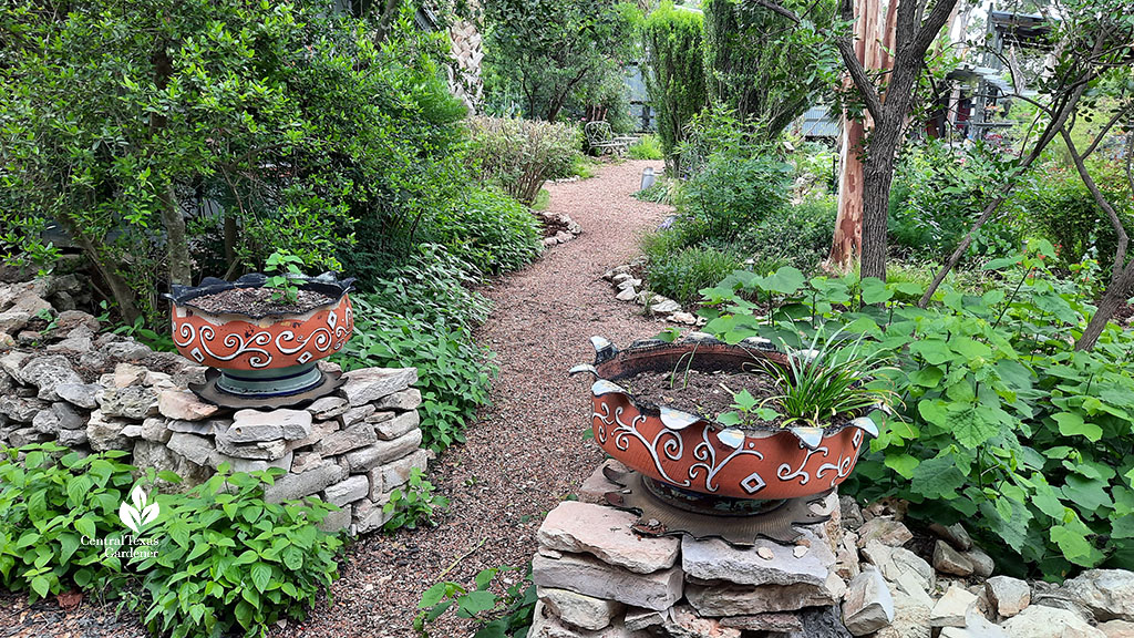 tire planters on short stone fence