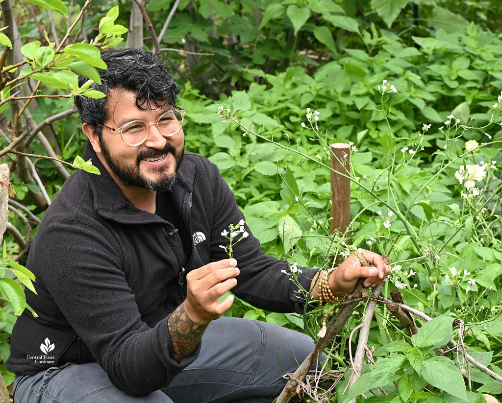 man holding a white radish flower 