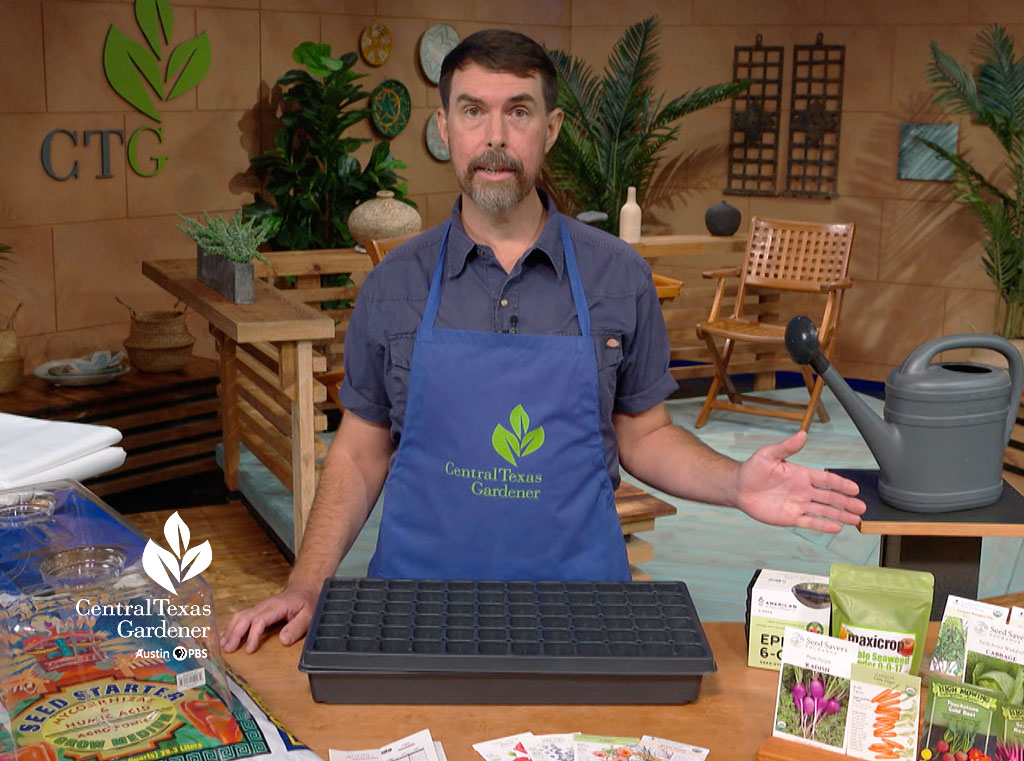 man on TV set with seed packets and seed starting equipment
