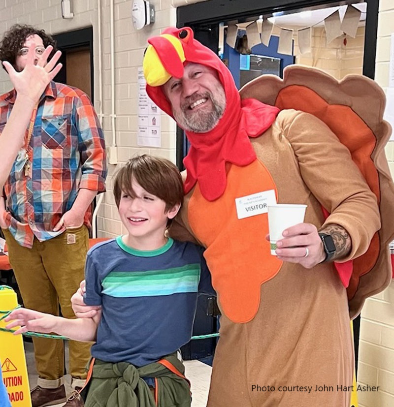 man in turkey costume with son at school 