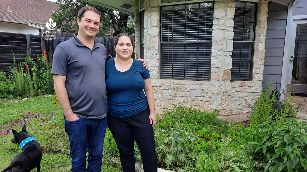 man, woman and dog in front yard 