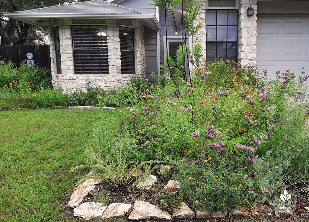 flower-filled small garden bed in front of house 