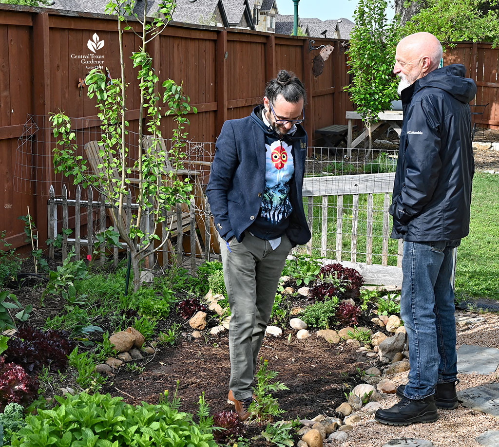 two men chatting in garden