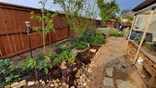 man entering side yard gate to narrow garden and stone path