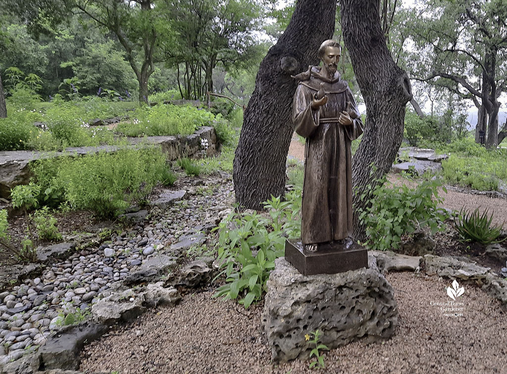 life-sized St. Francis sculpture against tree