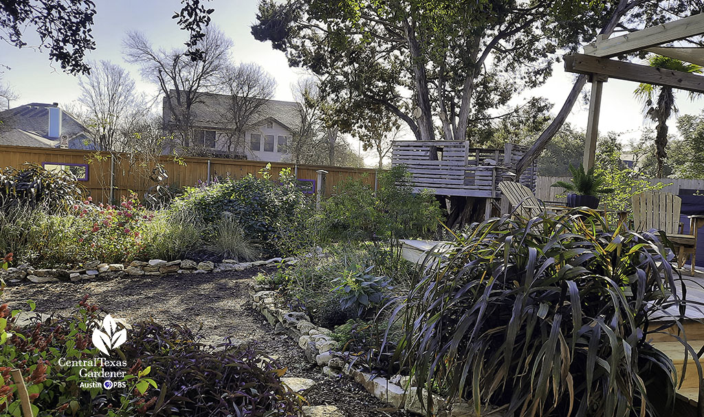 flagstones on mulch bordered by colorful flowers and grasses 