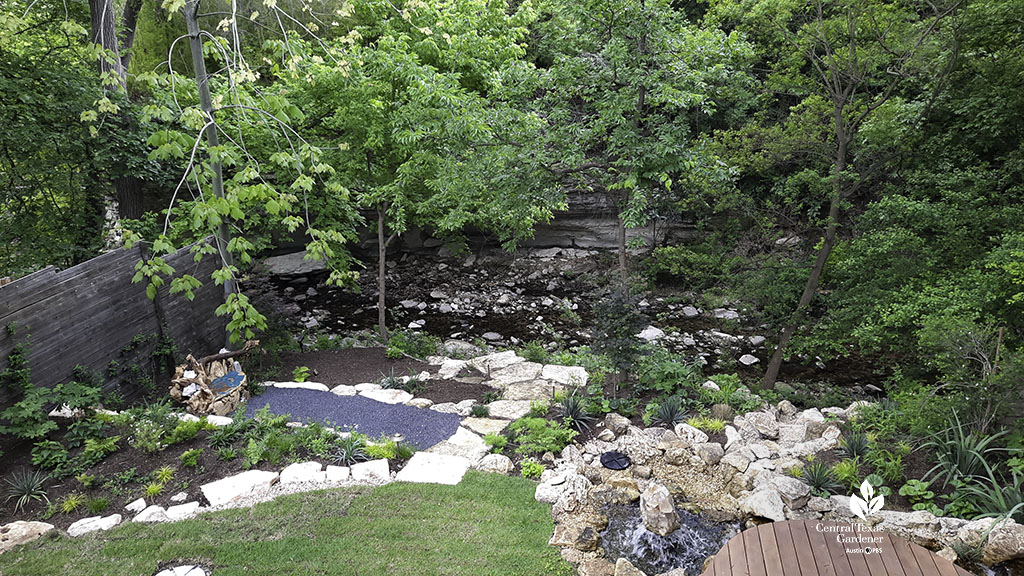 wide of backyard with garden beds, designed stream and Bouldin Creek at far back 