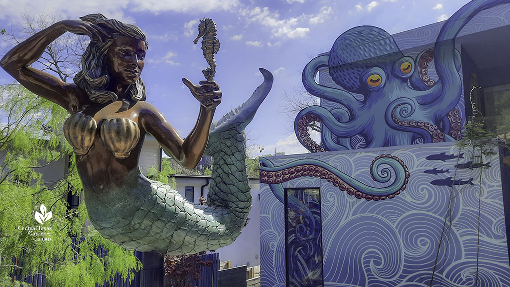 mermaid sculpture mounted on twirling post in front yard of house painted like an octopus