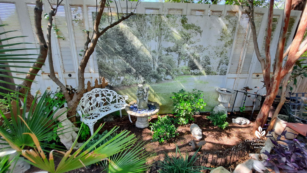 wall hanging painted like English garden in pale green; on either side ivory colored bifold doors 