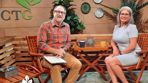 man and woman on television set with CTG logo on wall behind them