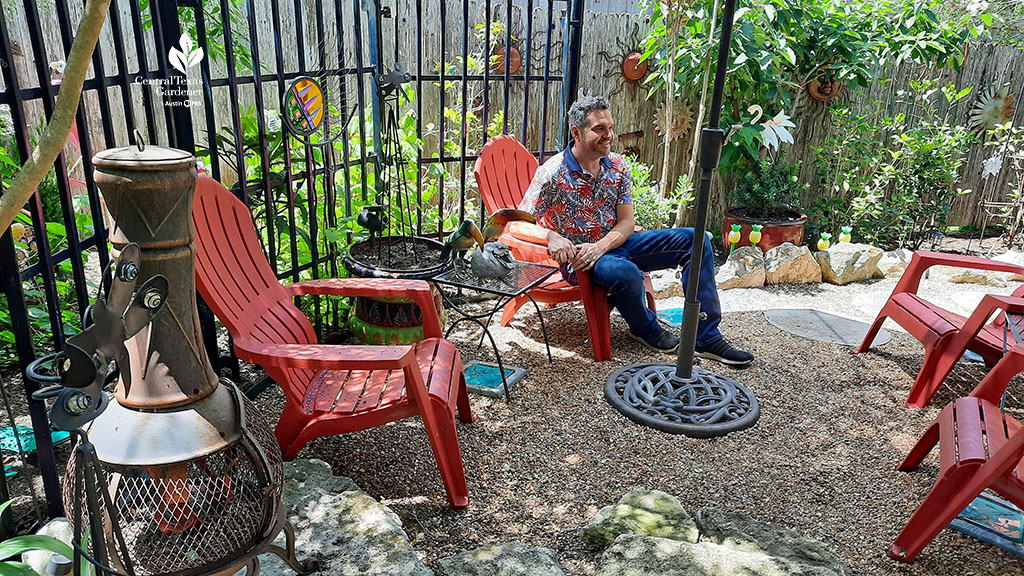 black bars as frame to outdoor room with red chairs and chimenea