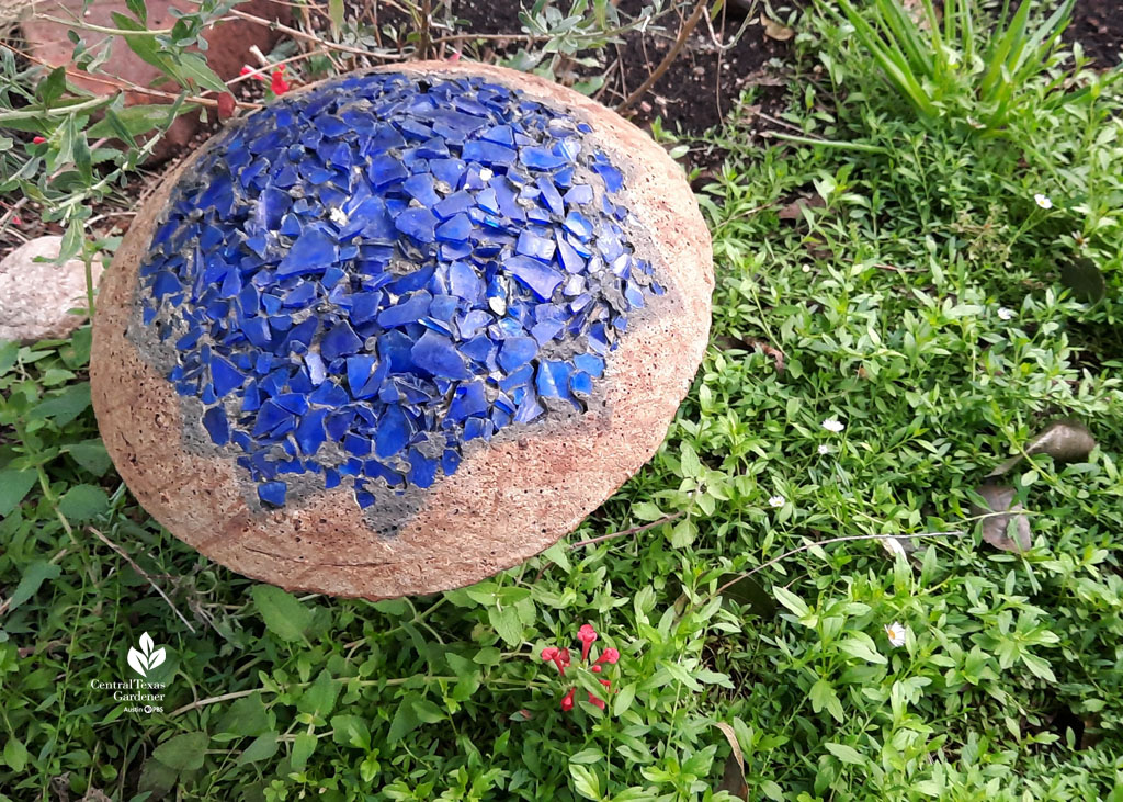 concrete mushroom with blue glass mosaic top