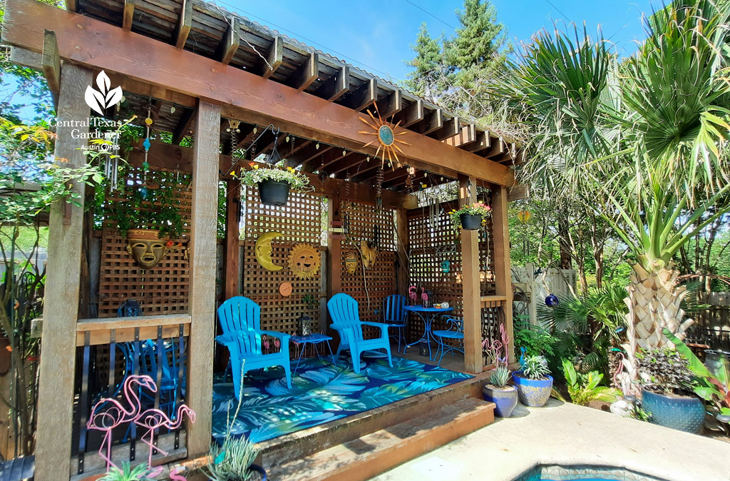 narrow cedar cabana with bright blue chairs and various wall hangings 