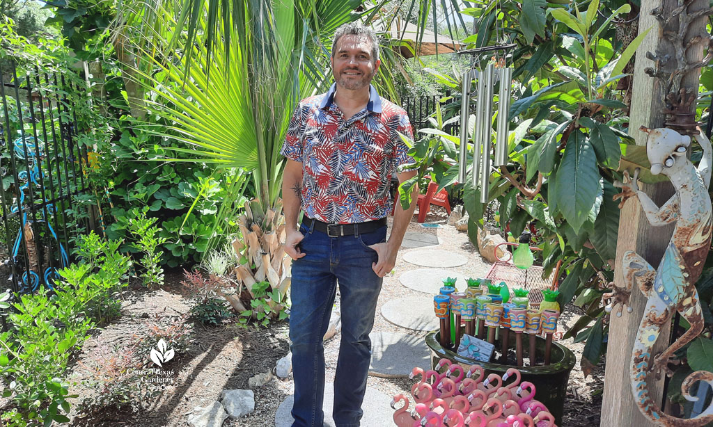 man on garden path against sabal palm 