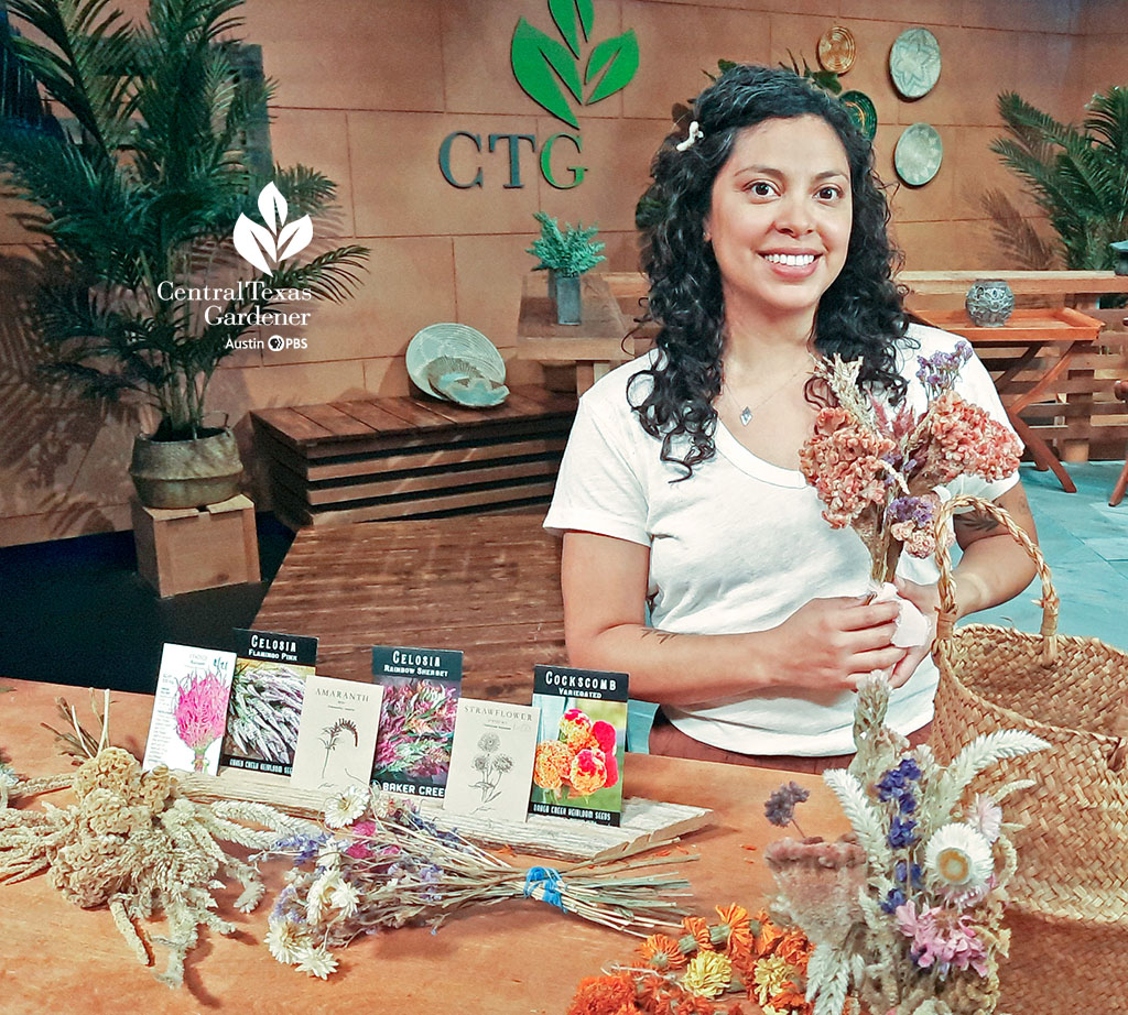 smiling woman on CTG set with colorful dried flowers and packets of seeds 