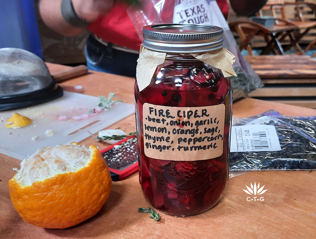 jar with bright red liquid concoction and label with ingredients 