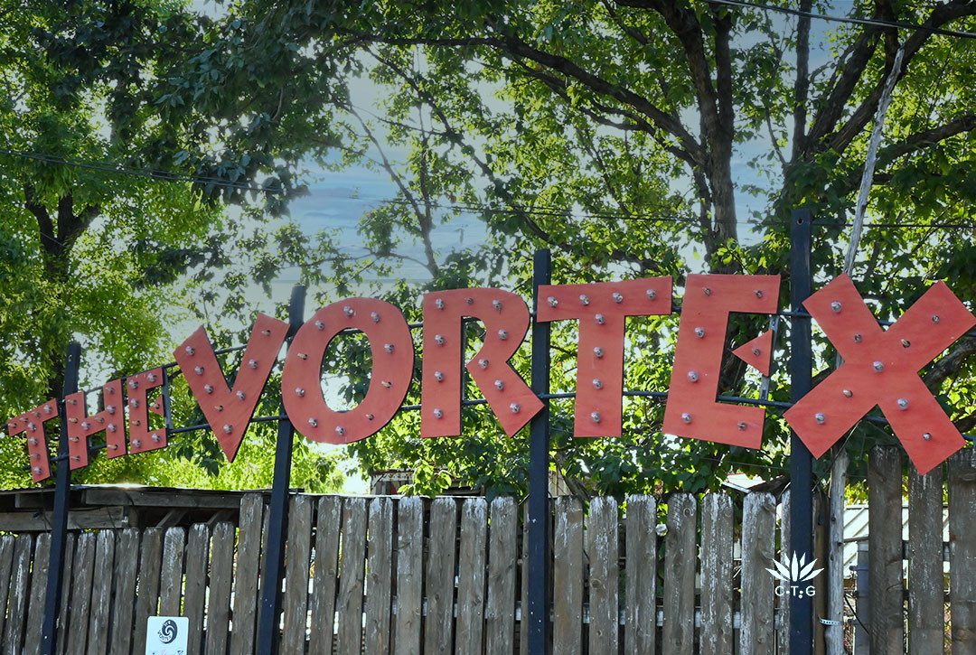 metal sign spelling out The Vortex