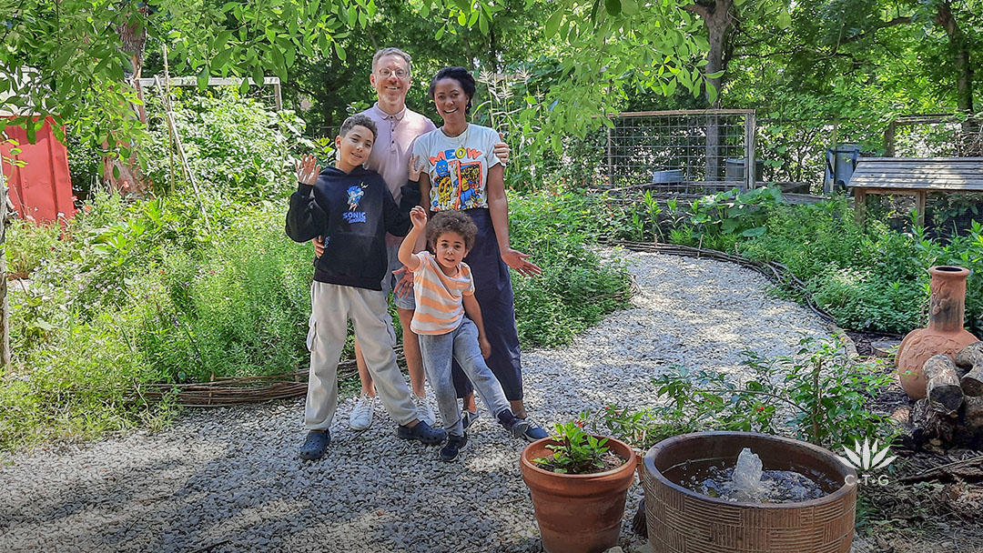 Richie and Nkiru Gelles with two young sons on garden path