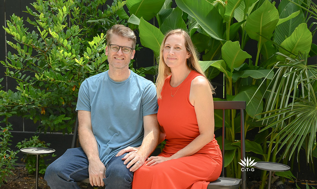 young man and woman on bench in their garden
