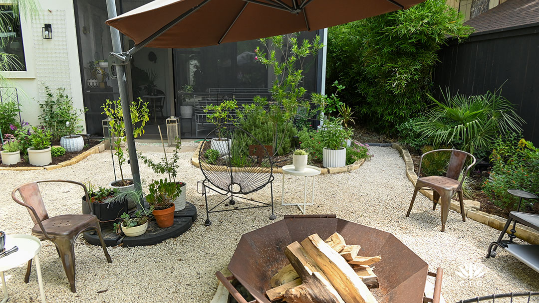 fire pit, screened in porch, black fence framed with plants of various sizes and textures