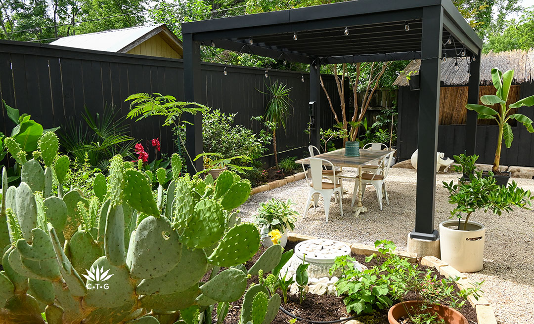 planting bed to black pergola and outdoor dining table 