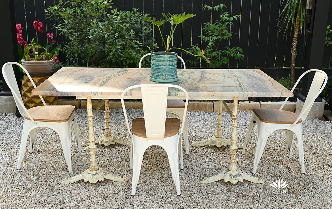 marble slab tabletop on vintage-looking off white table legs 