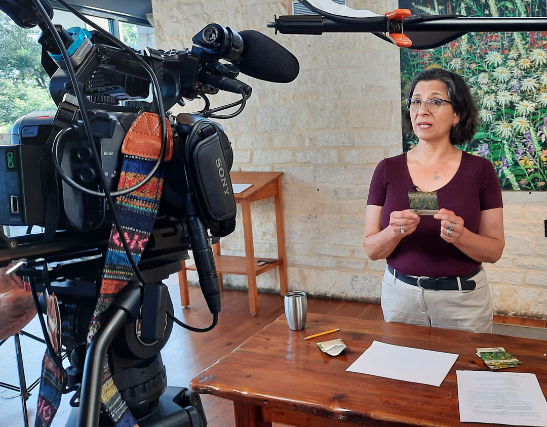 woman holding seed packet in front of camera 