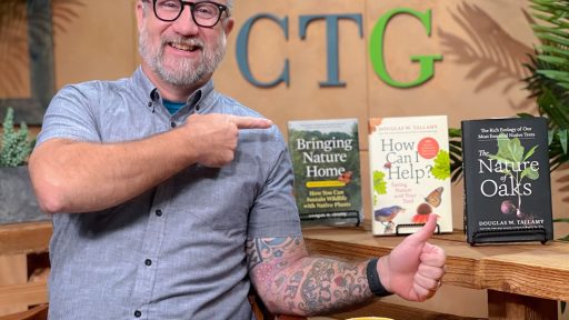 John Hart on CTG set pointing to books