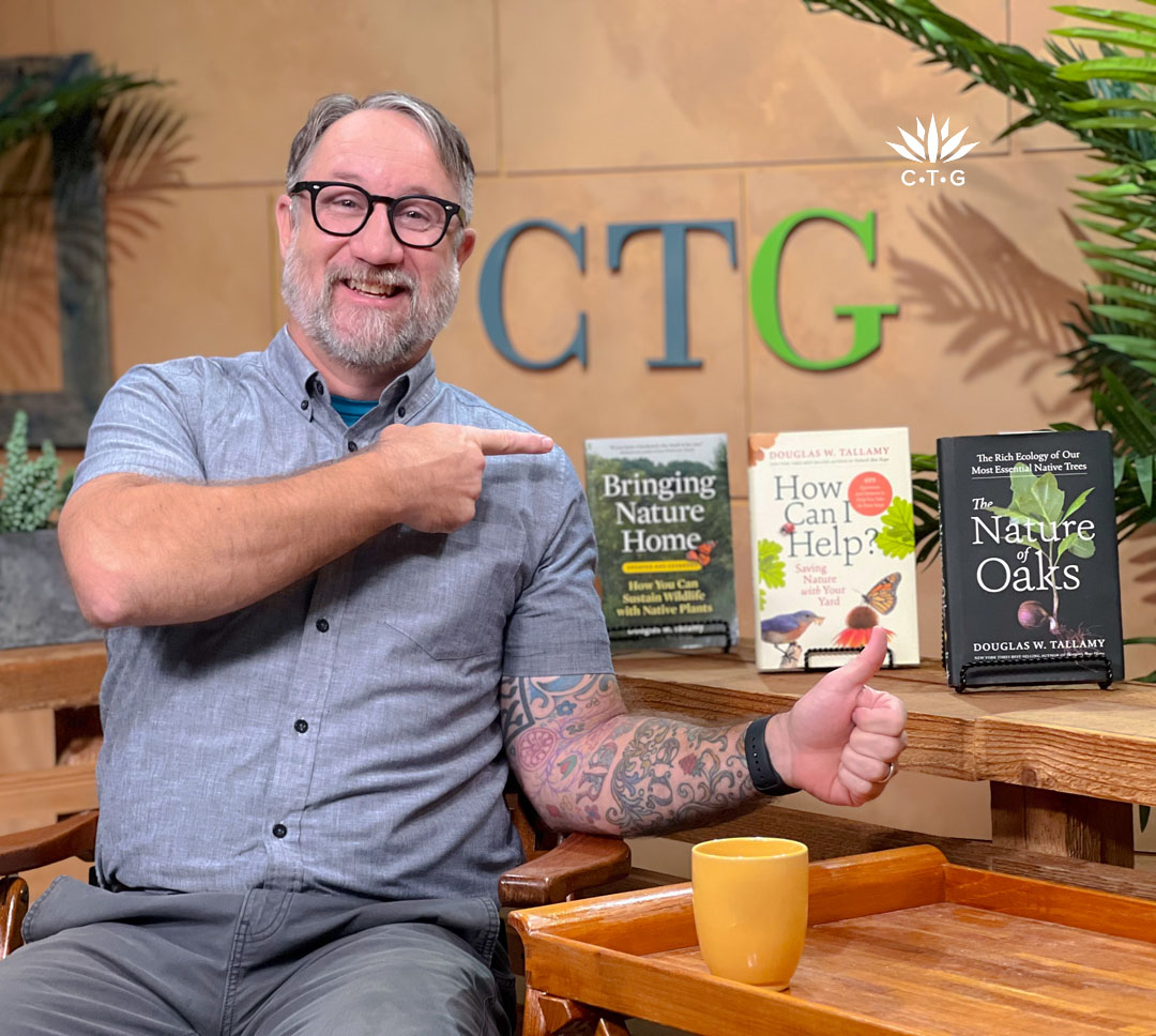 John Hart on CTG set pointing to books